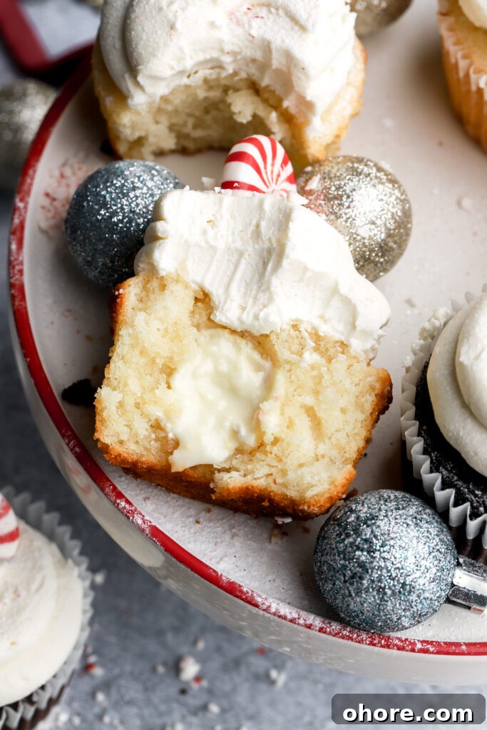 Refreshing Peppermint Cupcakes Recipe with Creamy Frosting 14 white chocolate peppermint cupcake cut in half with white chocolate peppermint truffle inside