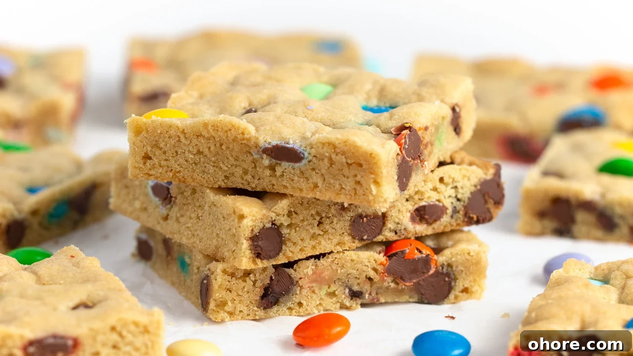 Chewy M&M Cookie Bars Recipe — Loaded Candy Cookie Bars 8 Stack of Chewy M&M Cookie bars cut into squares