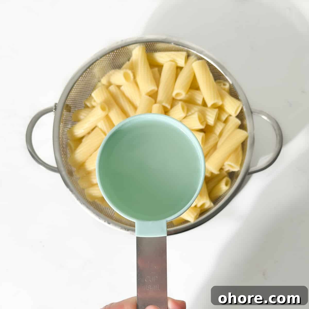 Reserving a cup of pasta water for the pasta.