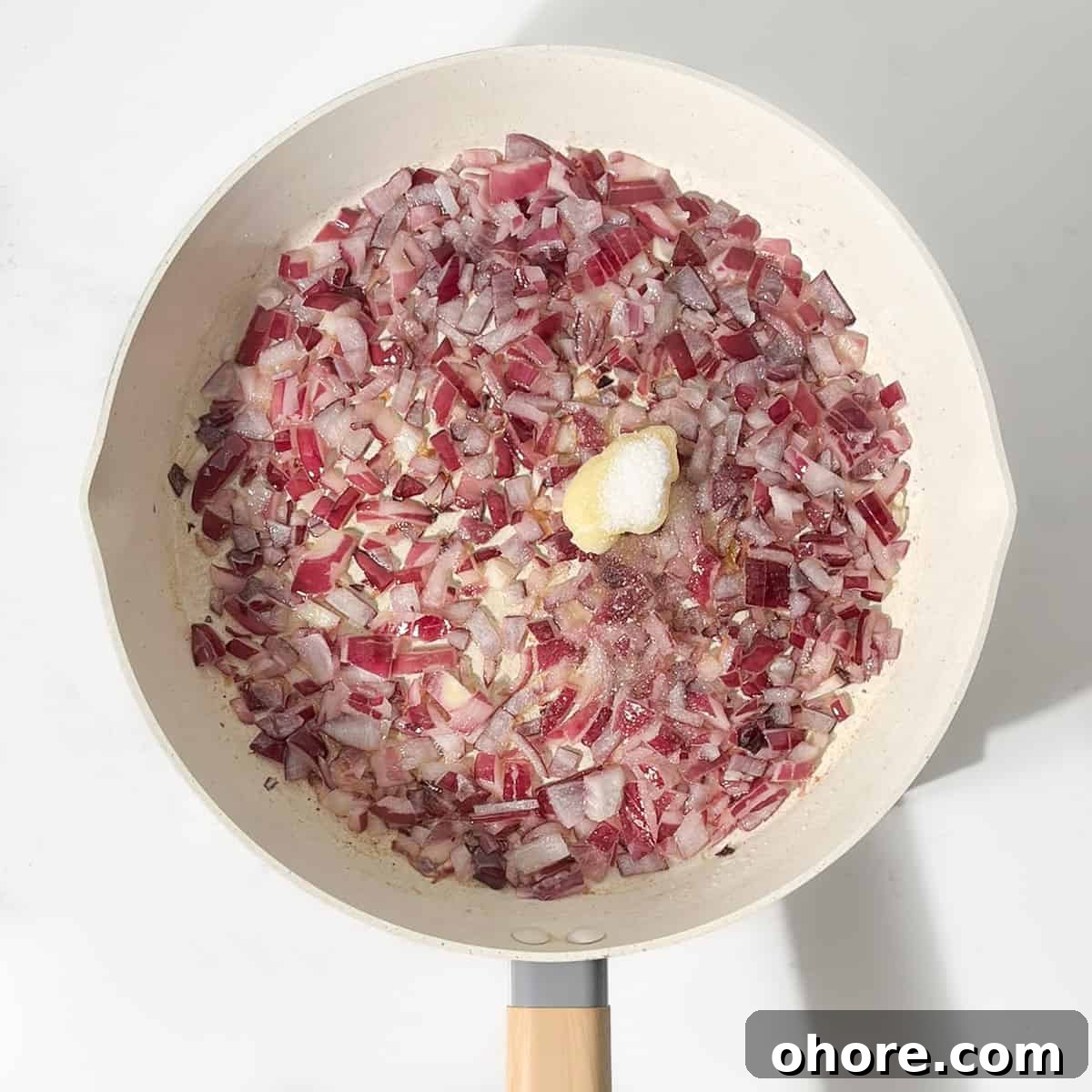 Adding garlic to the fried onions.