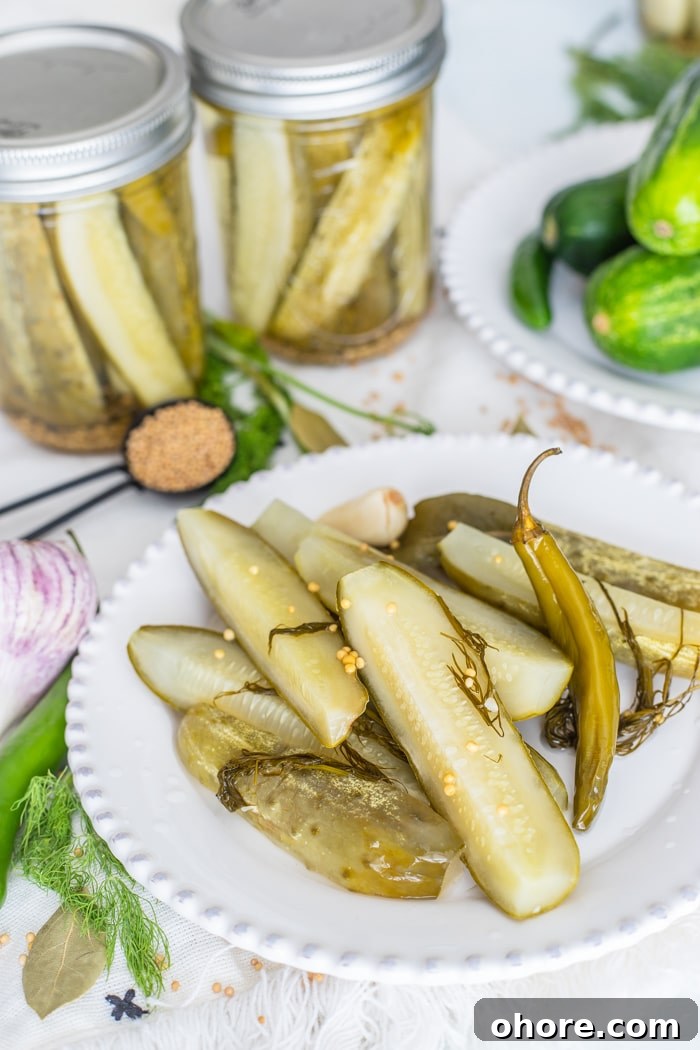 Dill Pickles Spears are easily made right in your own kitchen! dill pickle recipe for canning on a white plate