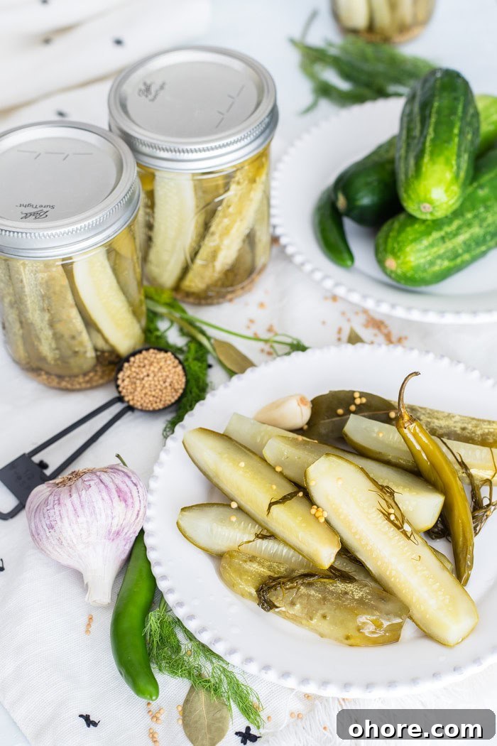Dill Pickles Spears are easily made right in your own kitchen! dill pickle recipe for canning on a white plate