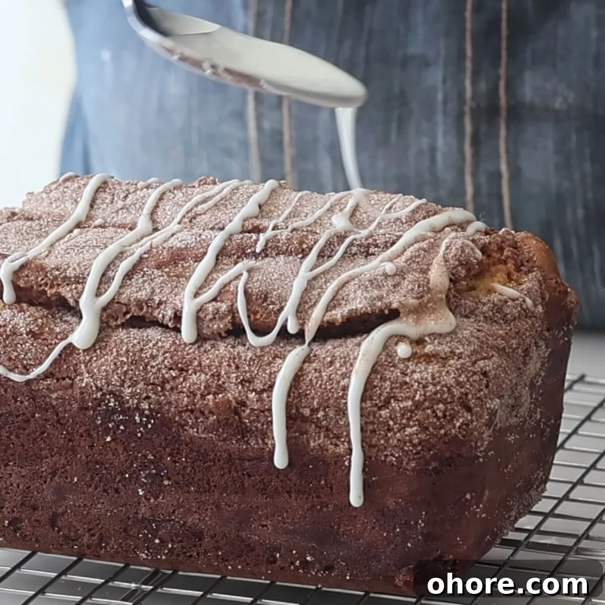 drizzling cinnamon bread with white icing.
