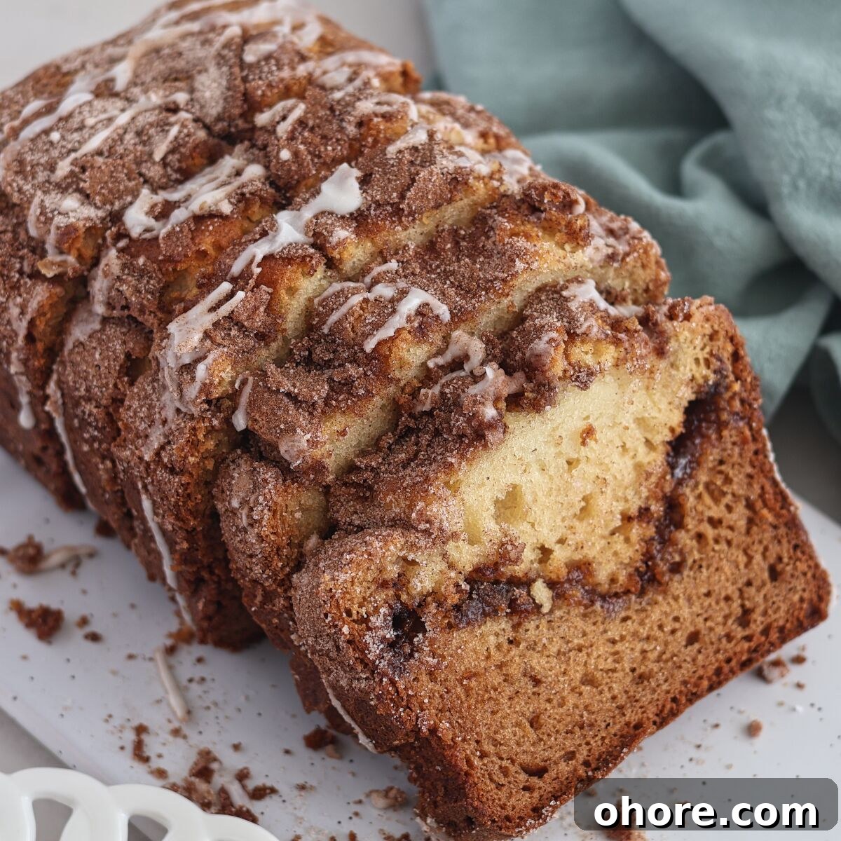 loaf of cinnamon bread sliced and placed on an angle.
