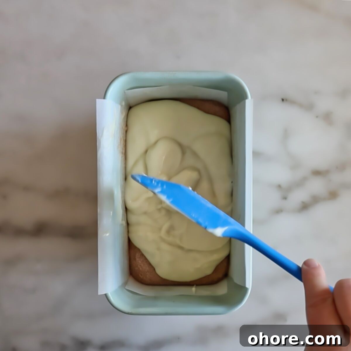 spreading the rest of the batter over cinnamon and sugar in light blue loaf pan.