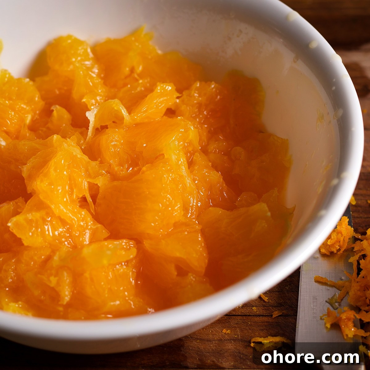 Orange Poppy Seed Cake with Mascarpone Frosting Recipe 10 A bowl filled with fresh orange pieces.