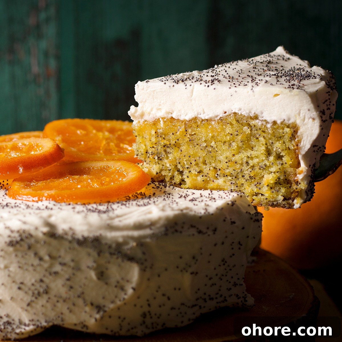 Orange Poppy Seed Cake with Mascarpone Frosting Recipe 20 Using a cake server to lift a slice of cake from an orange poppy seed cake.