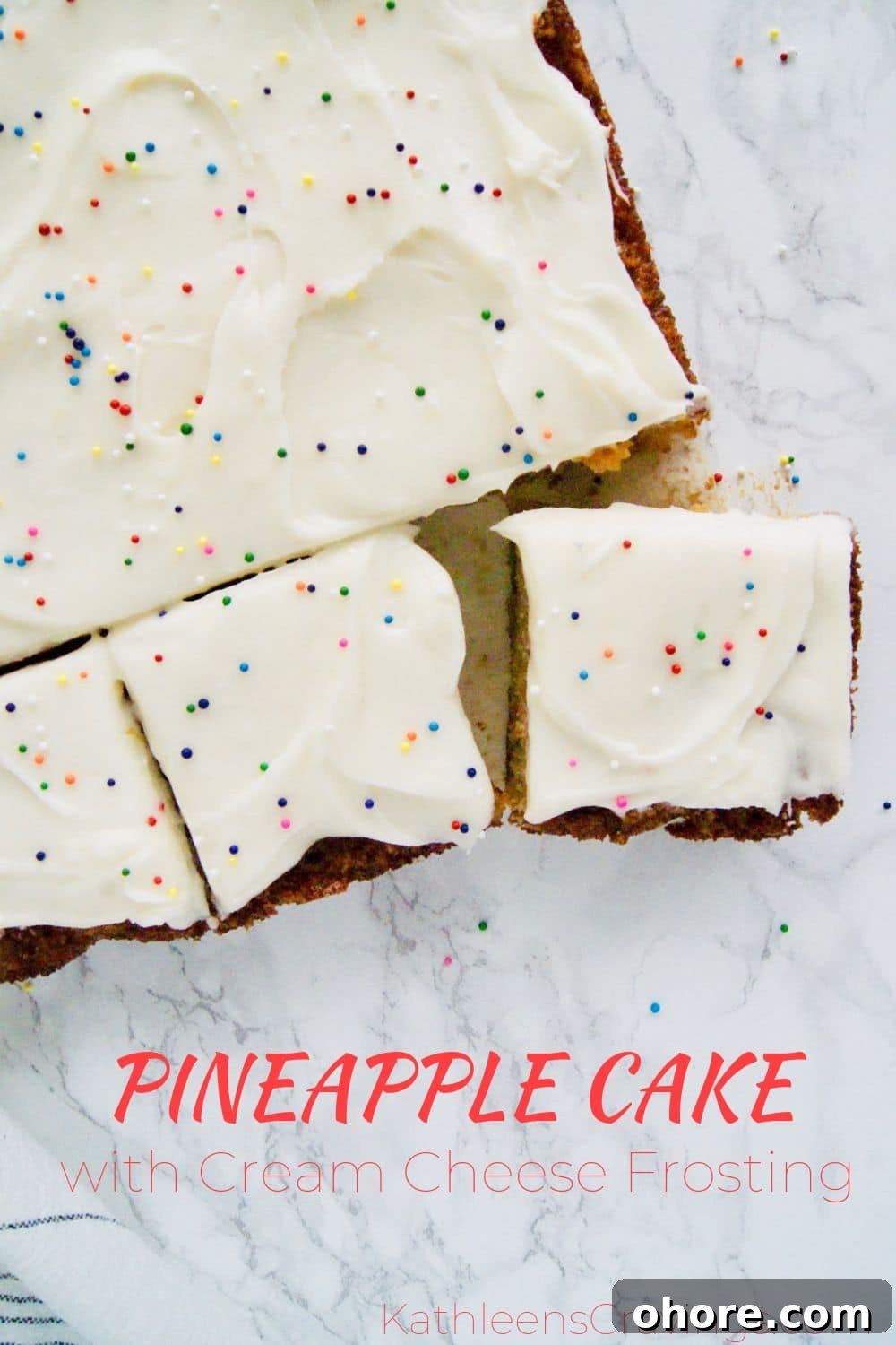 Pineapple cake with cream cheese frosting cut into pieces