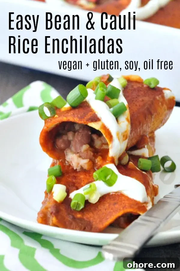 Easy Bean and Cauliflower Rice Enchiladas @spabettie #vegan #glutenfree #soyfree #oilfree #comfortfood one Bean and Cauliflower Rice Enchilada stacked on a second one, on a white plate next to a green and white cloth napkin, and a full pan of red sauce enchiladas in the background.