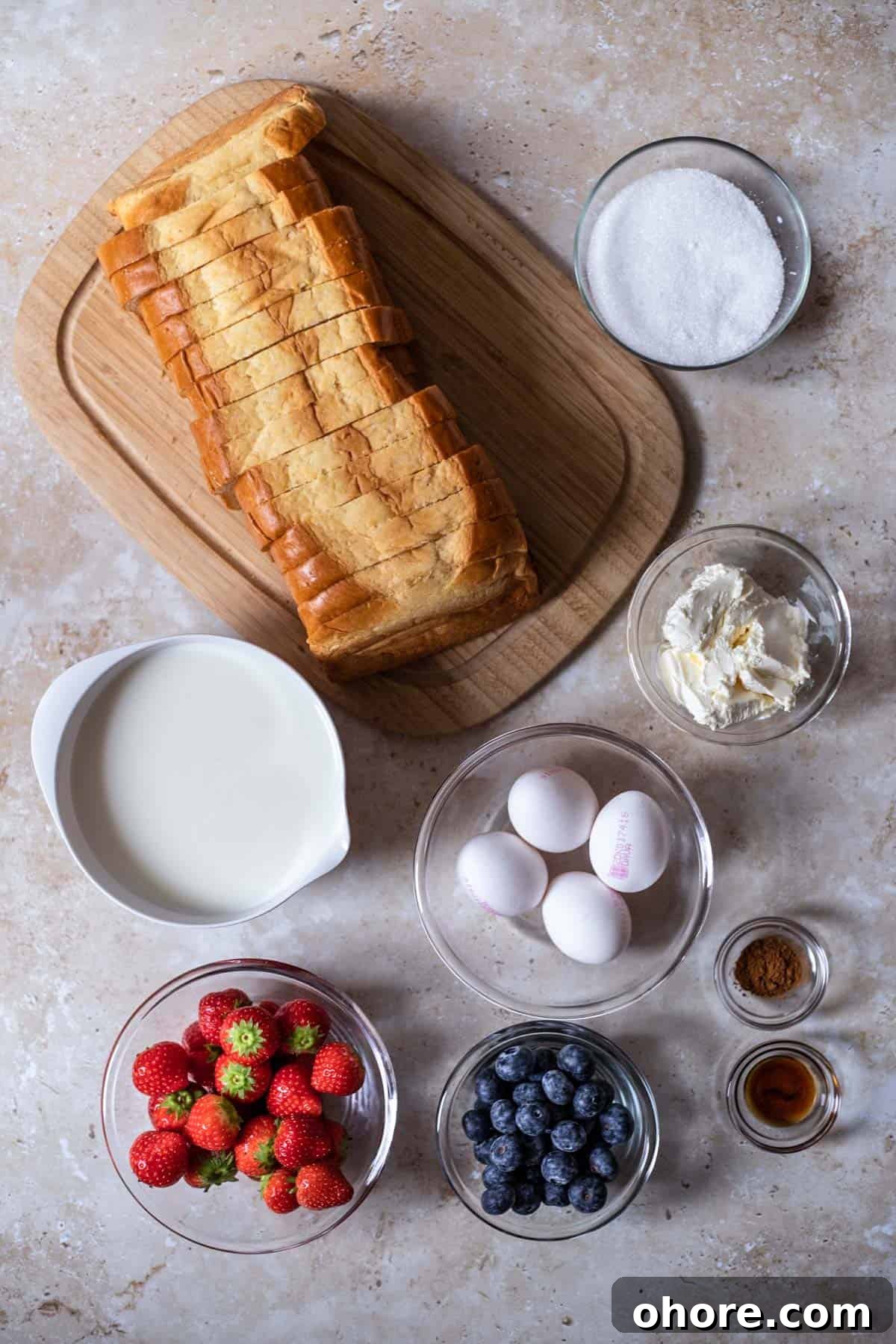 Berry Brioche Cream Cheese French Toast Bake for Brunch 3 a loaf of sliced bread, sugar, cream cheese, cinnamon, eggs, milk, strawberries, and blueberries