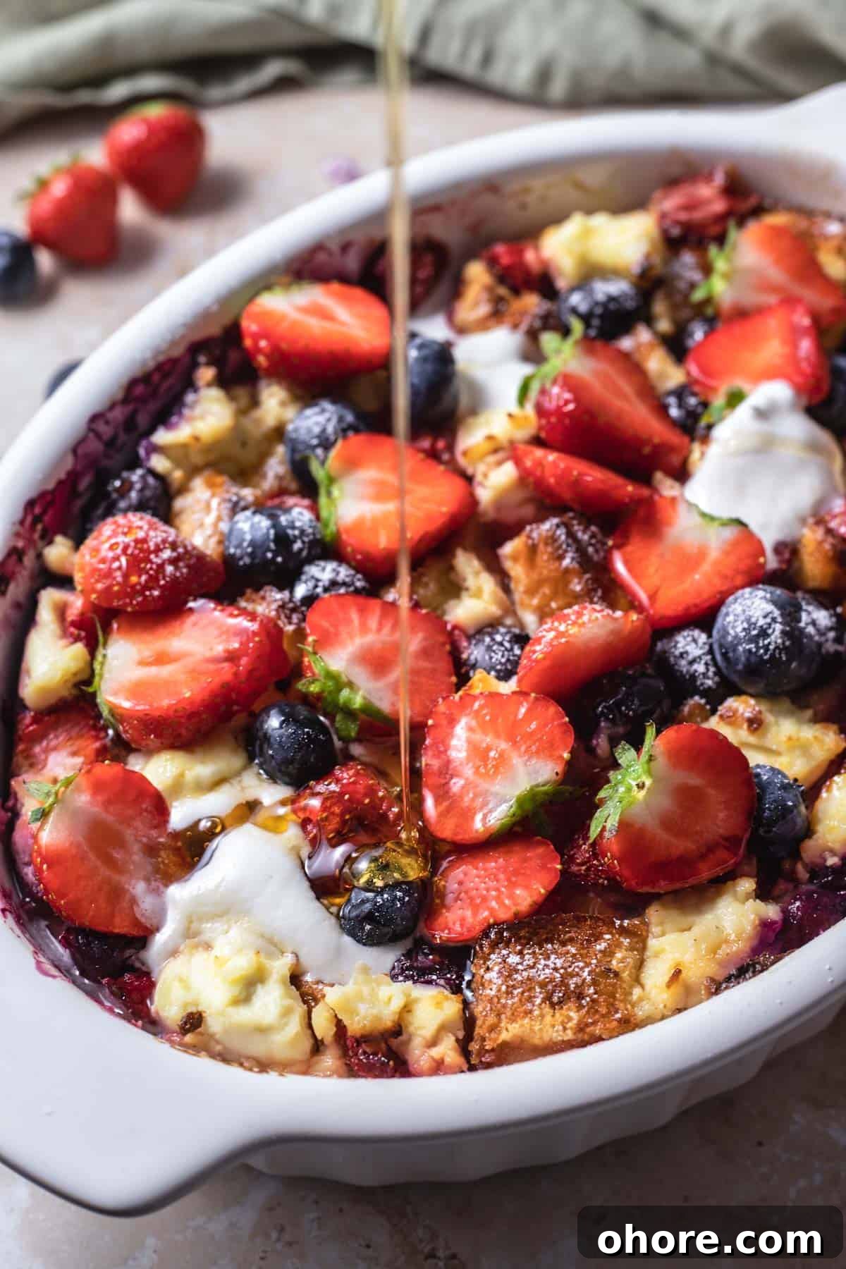 Berry Brioche Cream Cheese French Toast Bake for Brunch 8 syrup being drizzled over berry brioche cream cheese french toast