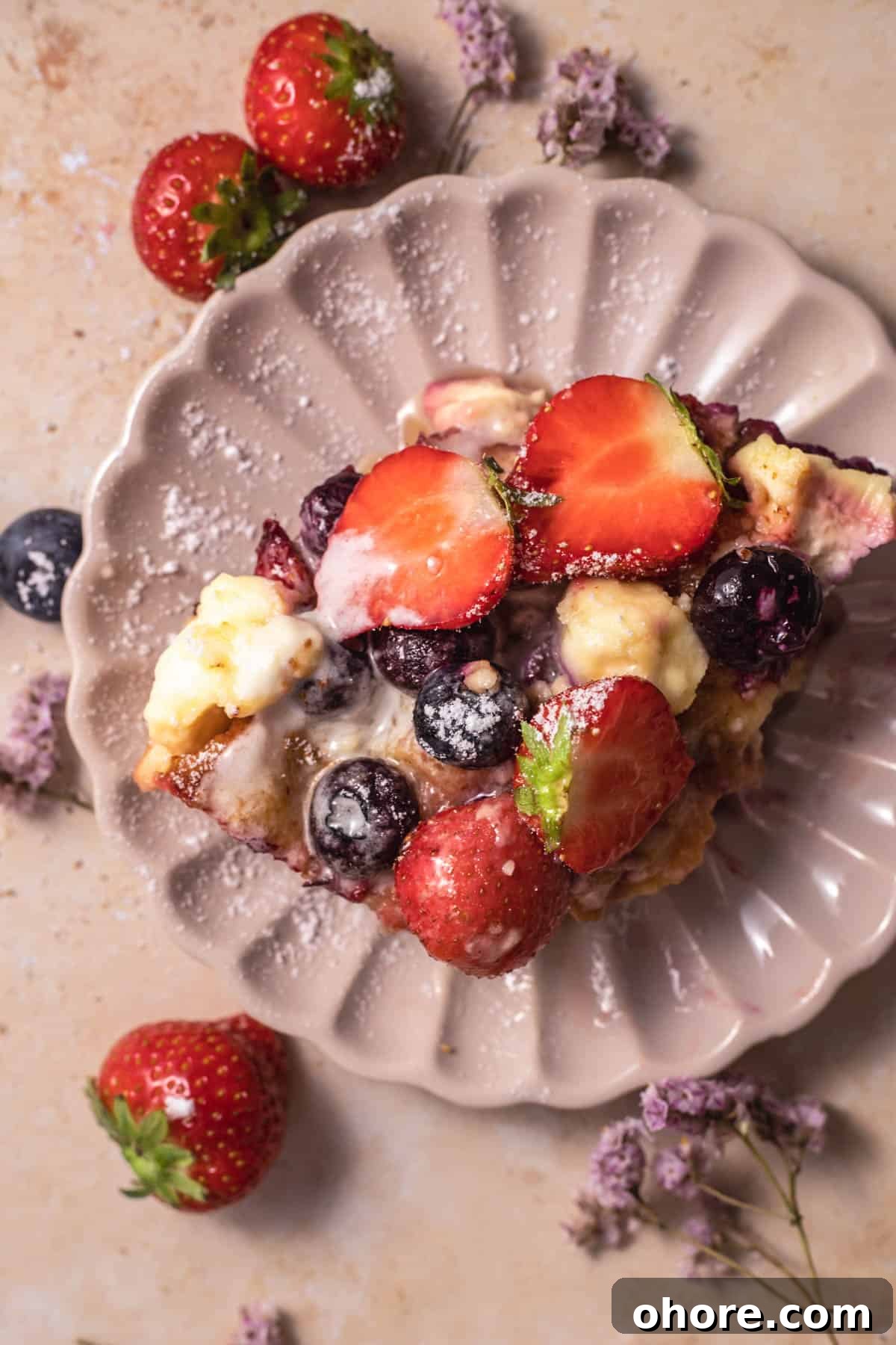 Berry Brioche Cream Cheese French Toast Bake for Brunch 9 a slice of berry brioche cream cheese french toast on a pink plate
