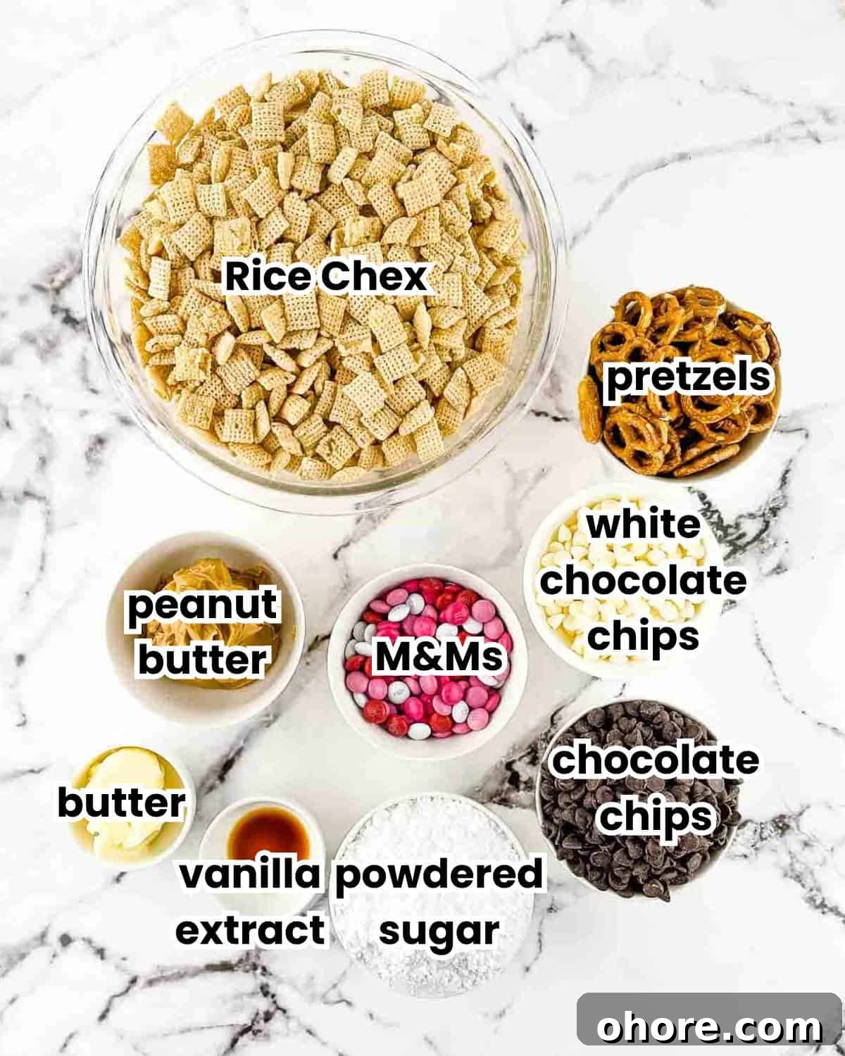 Valentine’s Puppy Chow: Festive Chocolate-Covered Snack Mix Recipe 3 The ingredients for Valentine's puppy chow measured out and placed on a white countertop.