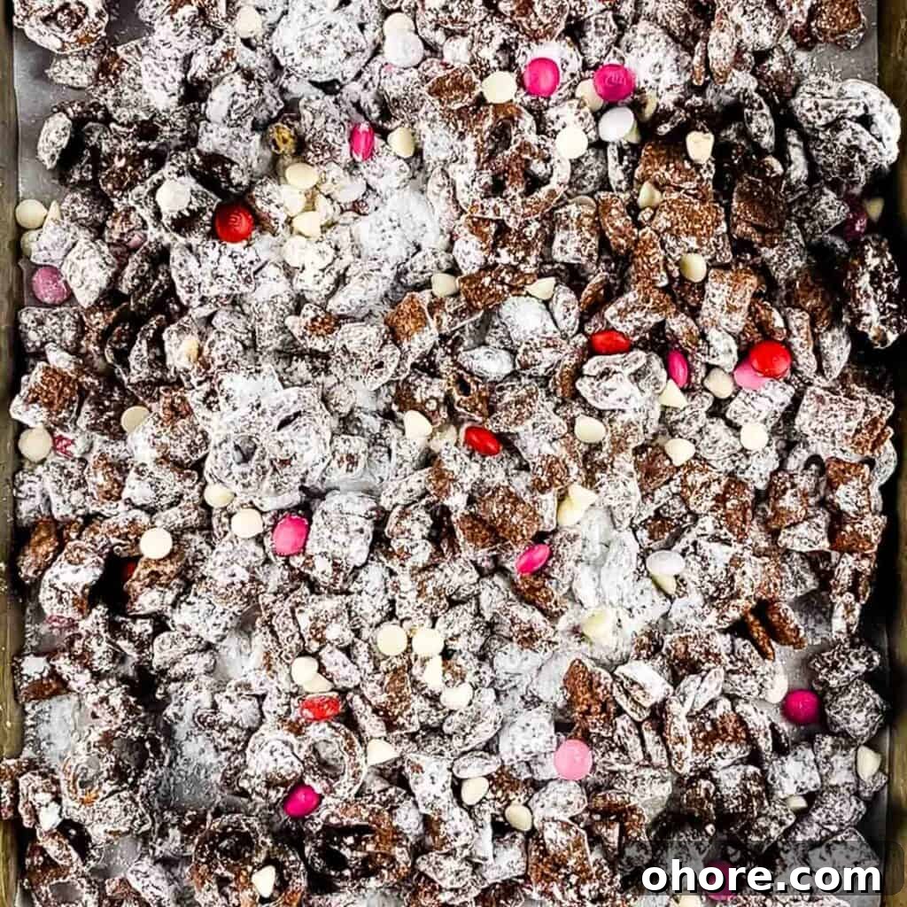 Valentine’s Puppy Chow: Festive Chocolate-Covered Snack Mix Recipe 8 The prepared puppy chow on a baking sheet.