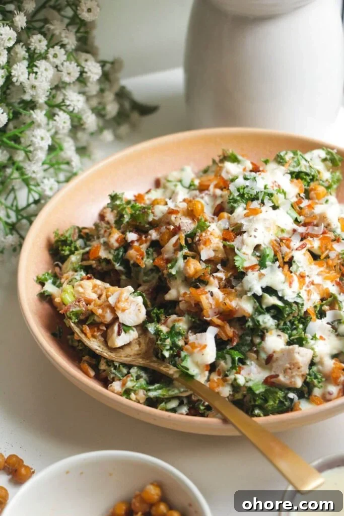 Crispy Rice Chicken Caesar Salad Recipe 11 Close up of Caesar rice salad in a pink bowl.
