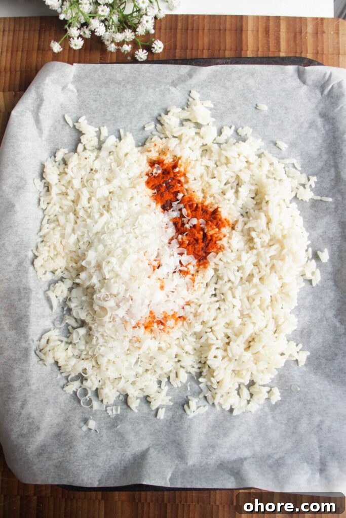 Crispy Rice Chicken Caesar Salad Recipe 4 Rice with paprika and parmesan on oven tray.