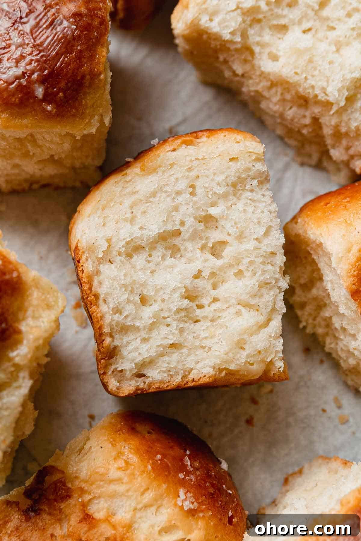 Soft Gluten-Free Dinner Rolls Recipe — Classic Homemade Rolls 10 Gluten free dinner roll on it's side showing soft texture.