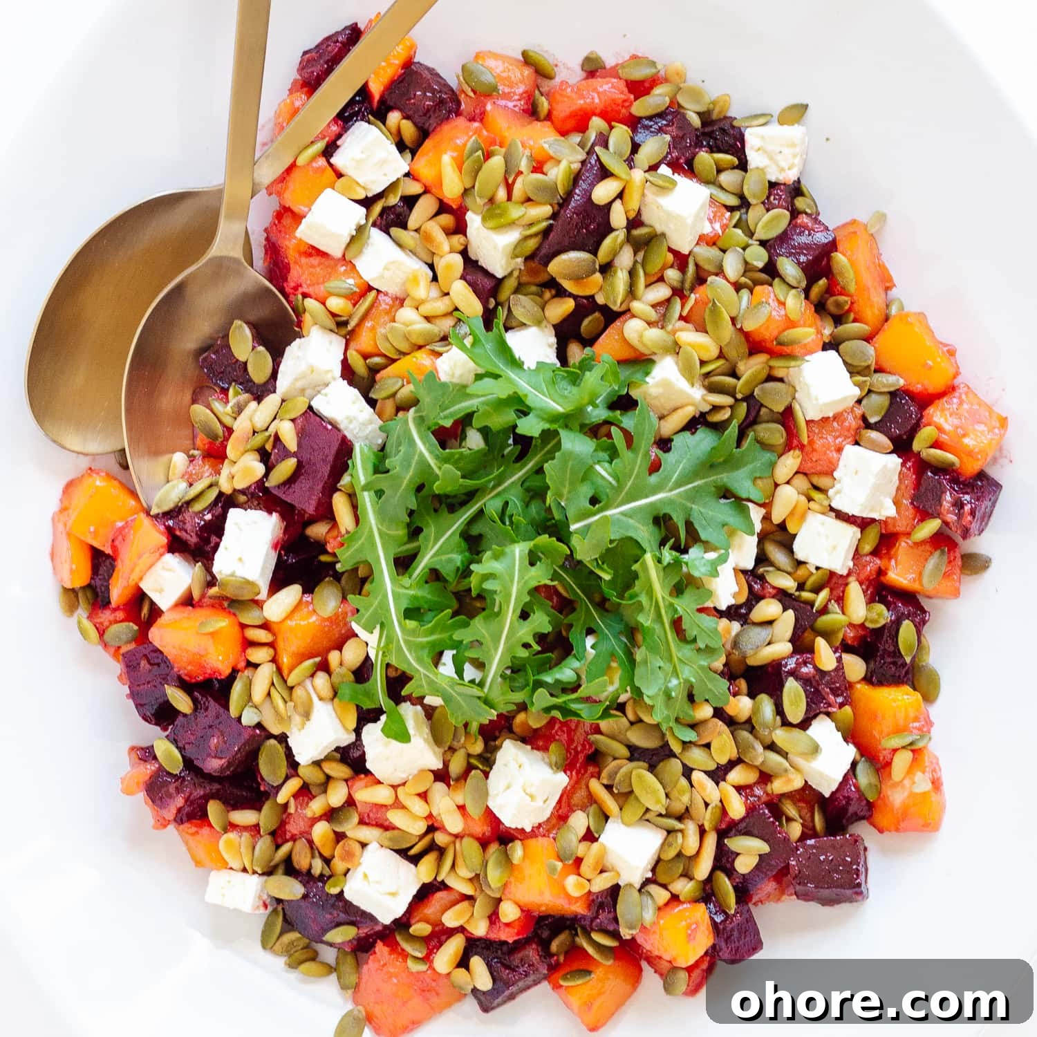 Roasted Pumpkin and Beetroot Salad with Feta and Toasted Seeds 11 Overhead photo of roasted pumpkin and beetroot salad topped with feta, pine nuts, pepitas and arugula.