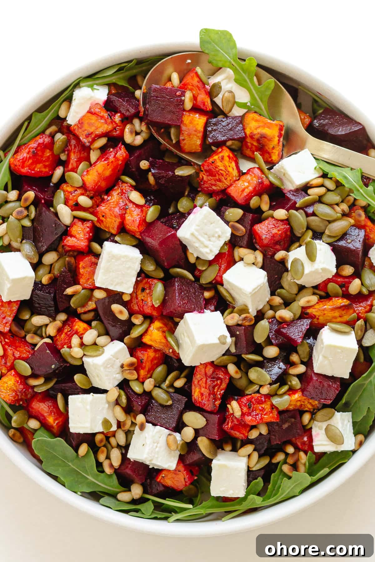 Roasted Pumpkin and Beetroot Salad with Feta and Toasted Seeds 13 Roast pumpkin and beetroot salad in a white serving bowl.
