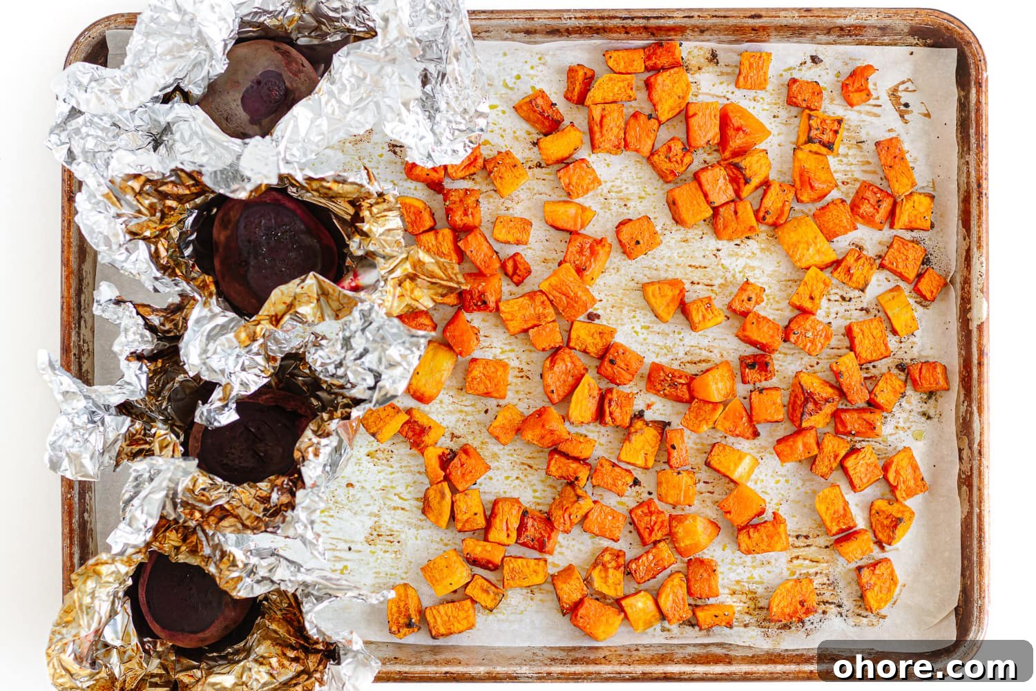 Roasted Pumpkin and Beetroot Salad with Feta and Toasted Seeds 6 Roasted cubed pumpkin and whole beets on a baking sheet.