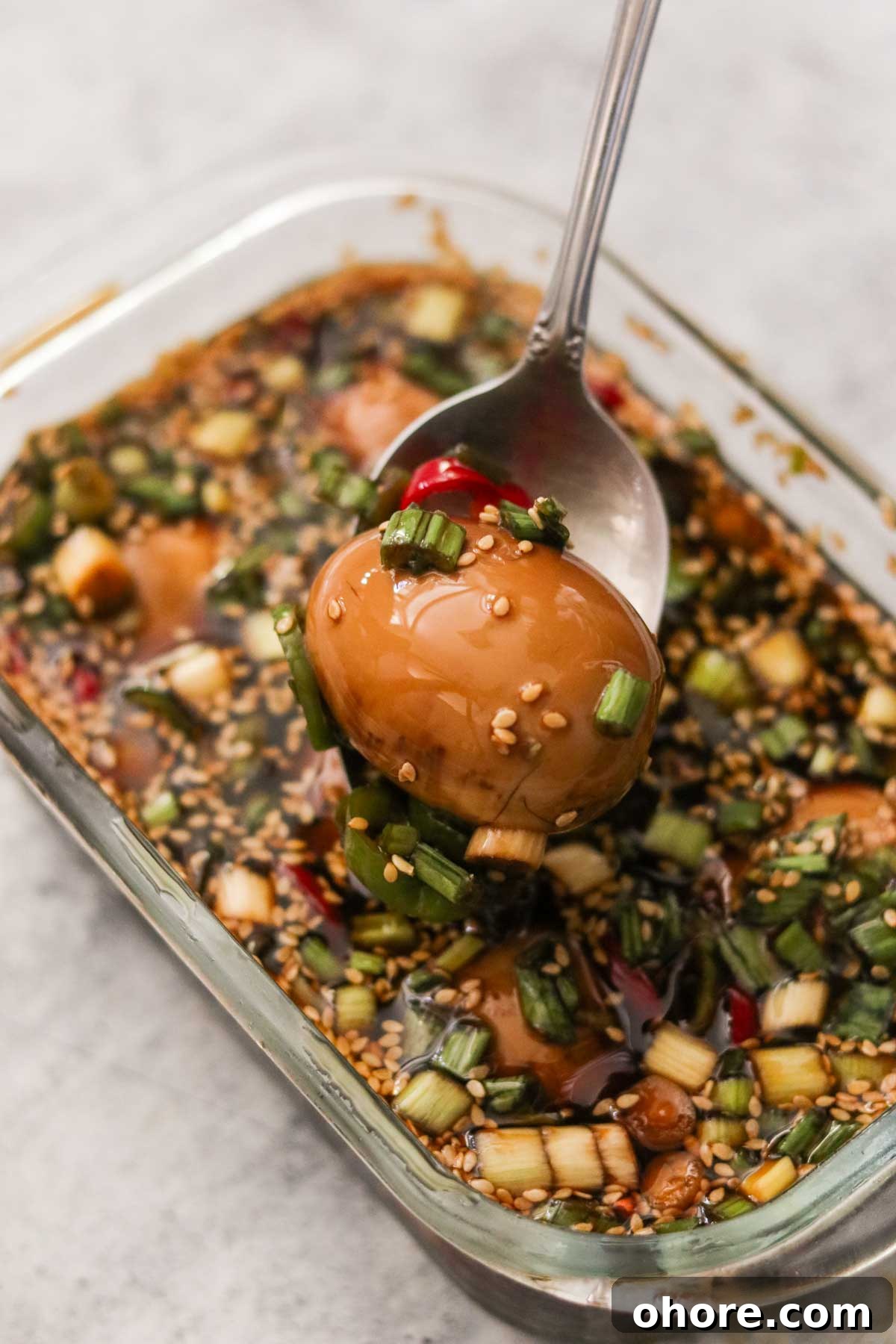 Removing a soft boiled egg from the marinade