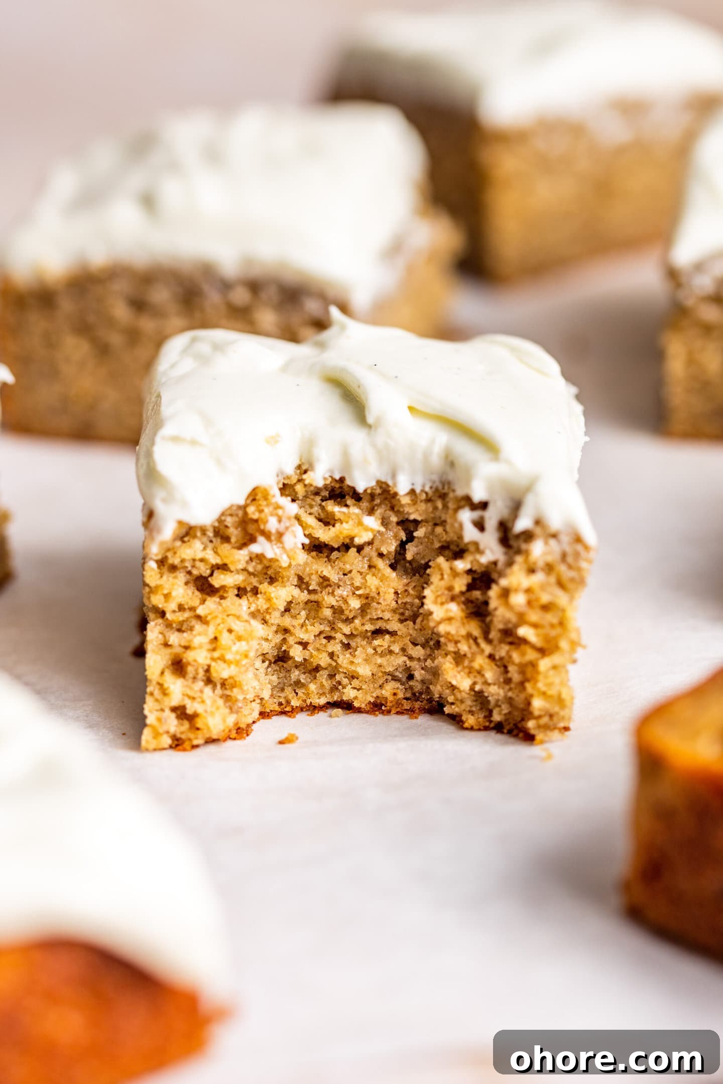 Cream Cheese Frosting with 5 Simple Ingredients 8 Close up of slice of Spiced Banana Snack Cake with a bite missing