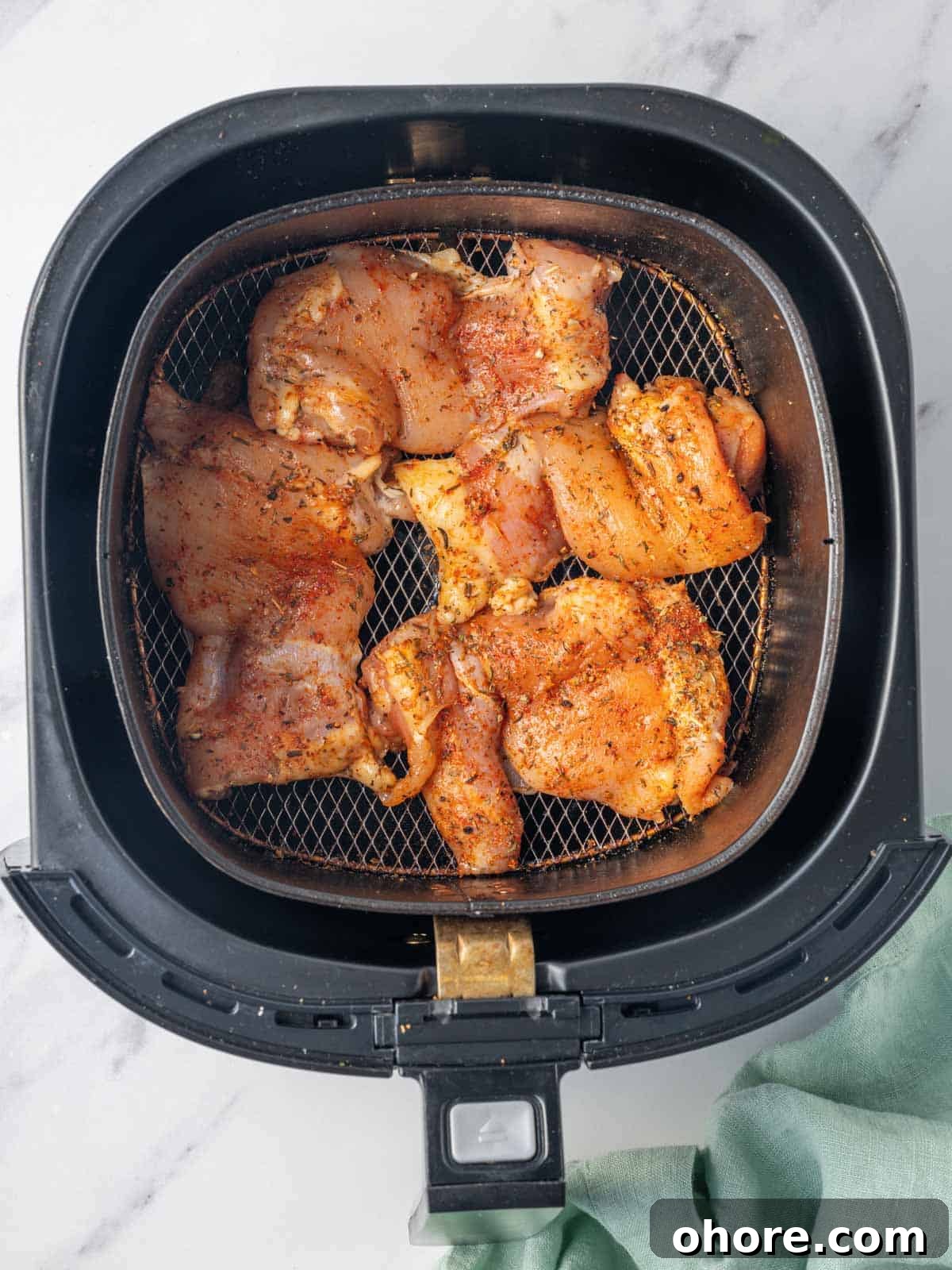 Crispy Air Fryer BBQ Chicken Recipe for Juicy, Quick Dinners 5 Chicken thighs ready to be cooked in the air fryer.