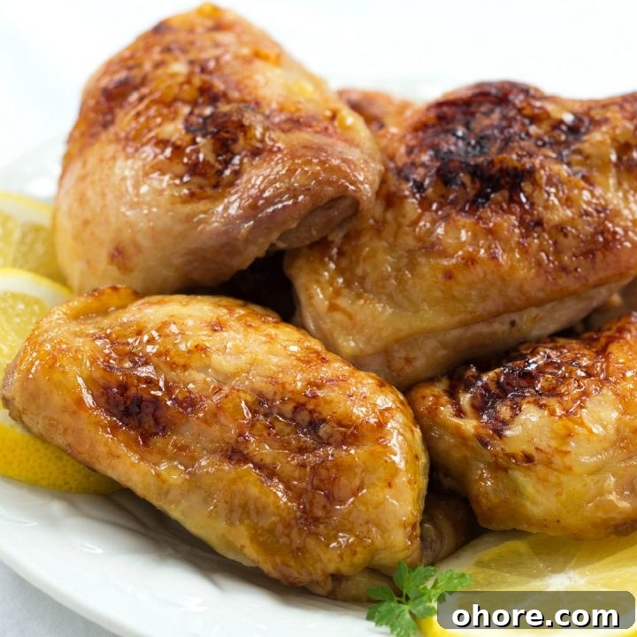 Week 34 Meal Plan for Group 2: Weekly Menu & Grocery List 4 Four pieces of baked chicken on a white plate with 3 lemon slices