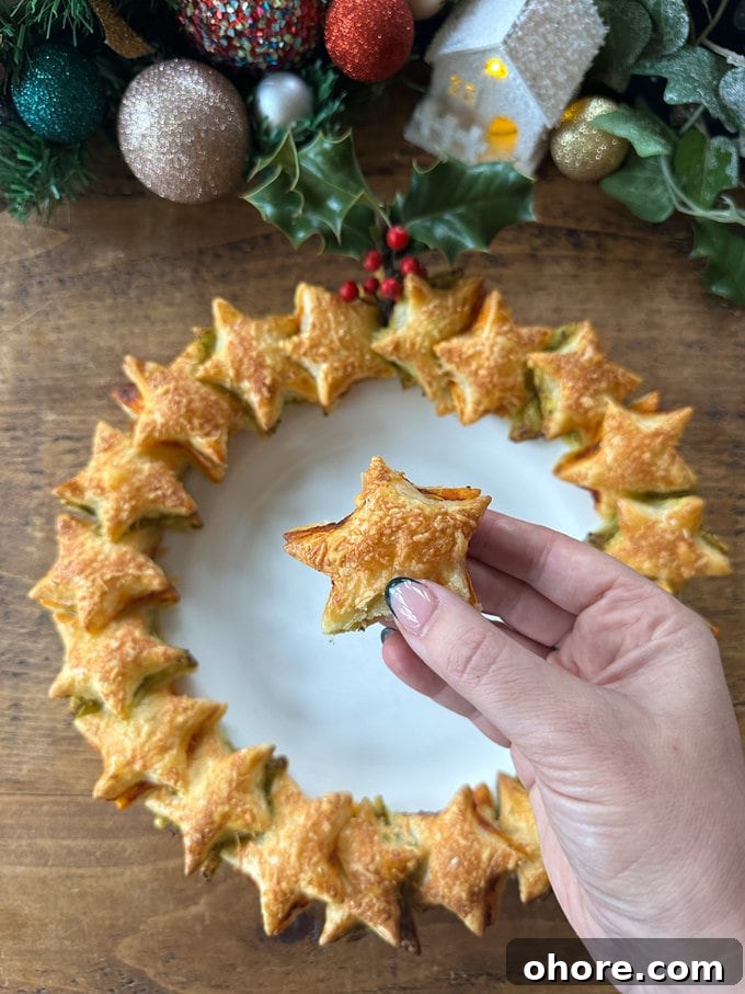 Pesto Puff Pastry Star Wreath Recipe for Holiday Appetizers 3 Star shaped puff pastry with red and green pesto,served on a round white plate. One of stars is close to the camera to show you a close up.
