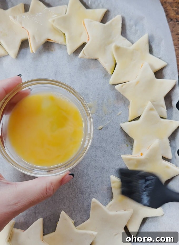 Pesto Puff Pastry Star Wreath Recipe for Holiday Appetizers 8 Star wreath being egg washed ready for the oven.