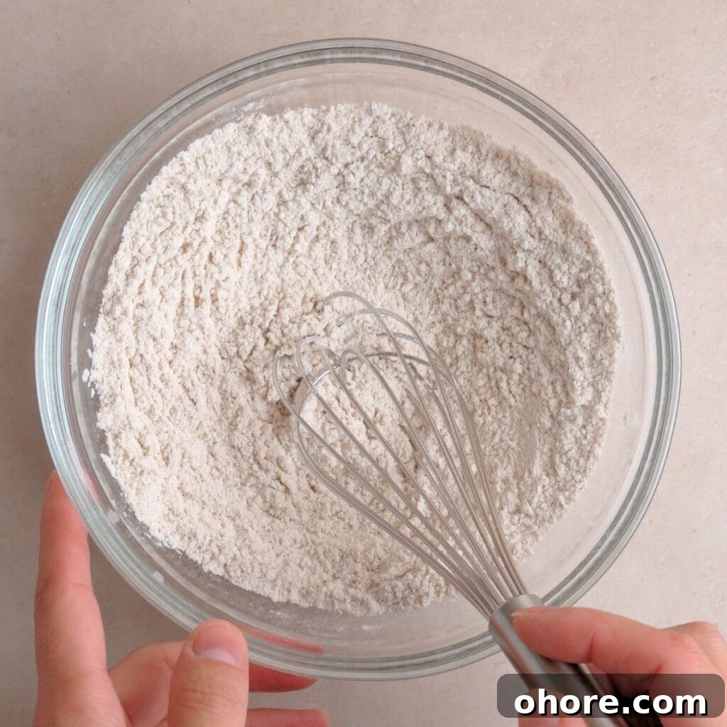 Flour, cinnamon, baking soda, and salt whisked together in a bowl.