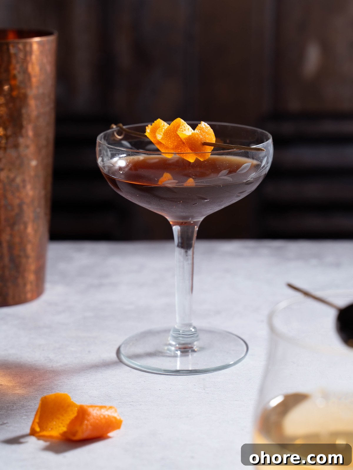 Nocino Negroni: A Dark Twist on the Manhattan Cocktail 2 A Nocino Black Manhattan cocktail garnished with orange peel