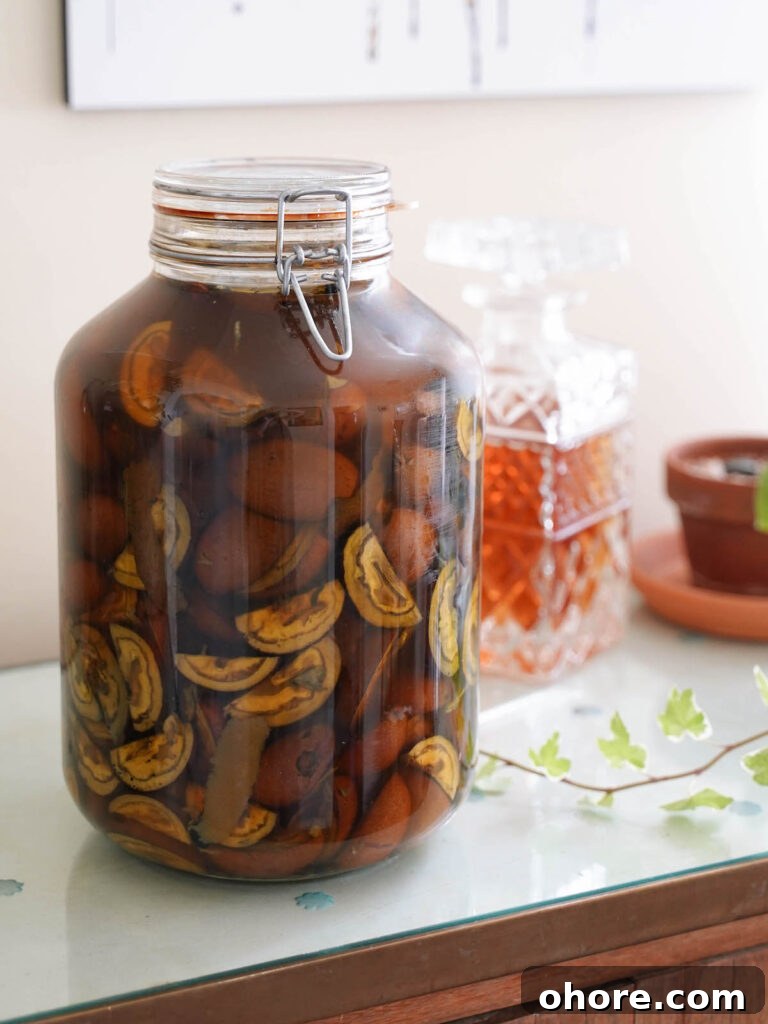 Nocino Negroni: A Dark Twist on the Manhattan Cocktail 3 A jar of nocino macerating