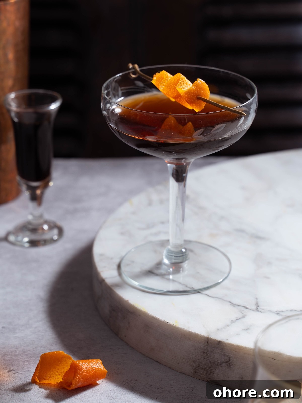 Nocino Negroni: A Dark Twist on the Manhattan Cocktail 6 A nocino cocktail served up in a coupe glass
