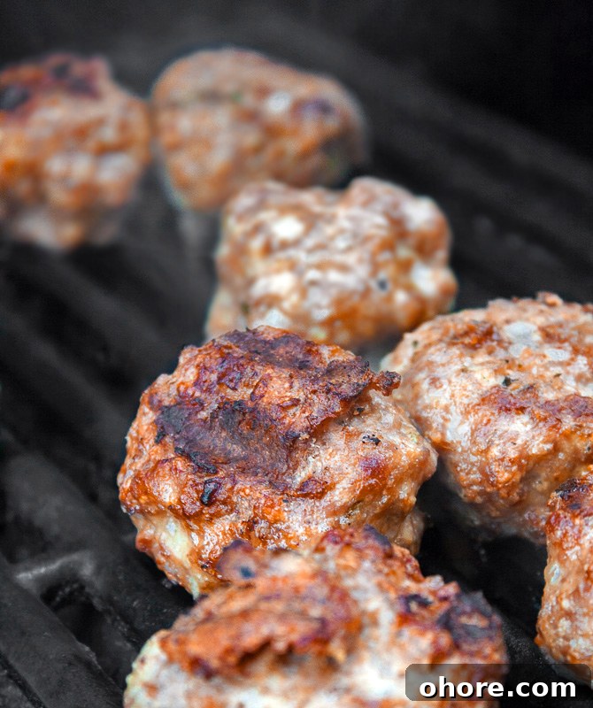 Gluten-Free Grilled Meatball Hoagies Recipe 4 Meatballs cooking on the BBQ; Grilled Meatball Hoagie Sandwiches with Spicy Tomato Sauce and Melted Cheese © 2018 Jane Bonacci, The Heritage Cook