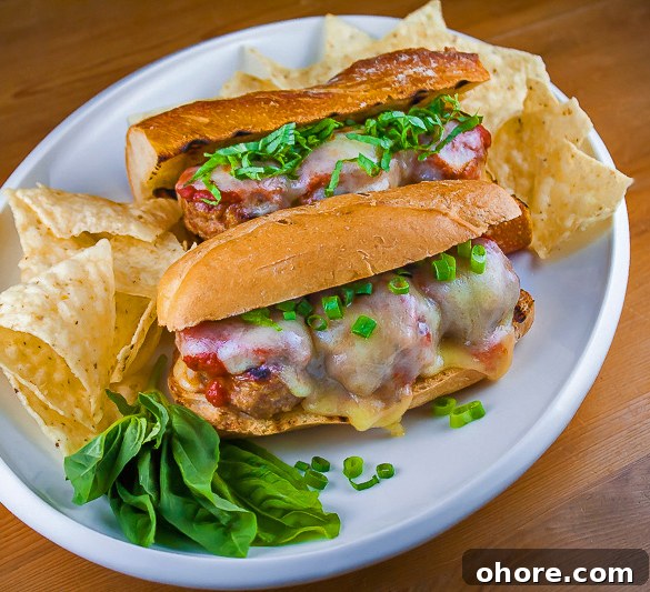 Gluten-Free Grilled Meatball Hoagies Recipe 6 Top down view of platter with 2 sandwiches and tortilla chips; Grilled Meatball Hoagie Sandwiches with Spicy Tomato Sauce and Melted Cheese © 2018 Jane Bonacci, The Heritage Cook