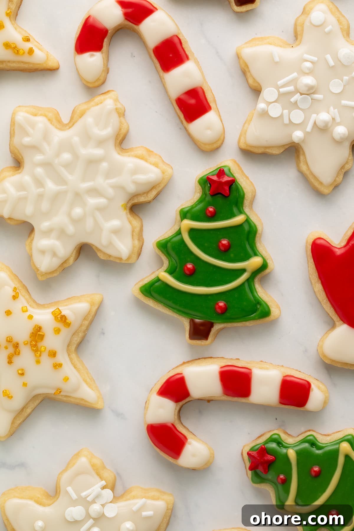 Vegan Christmas Cookie Recipes for Holiday Baking 4 Close up of Christmas cookies with green, white, red, and yellow frosting.