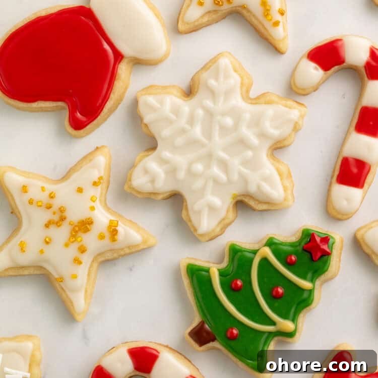 Vegan Christmas Cookie Recipes for Holiday Baking 5 Christmas cookies decorated as a star, a snowflake, a tree, candy canes, gloves and a pair of mittens.
