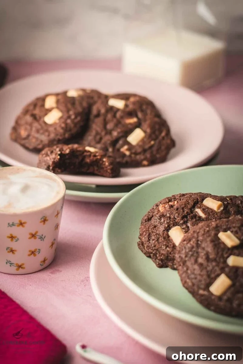 Divine white chocolate chip cookies with an incredible dark chocolate dough. Placed on pink-green plates.