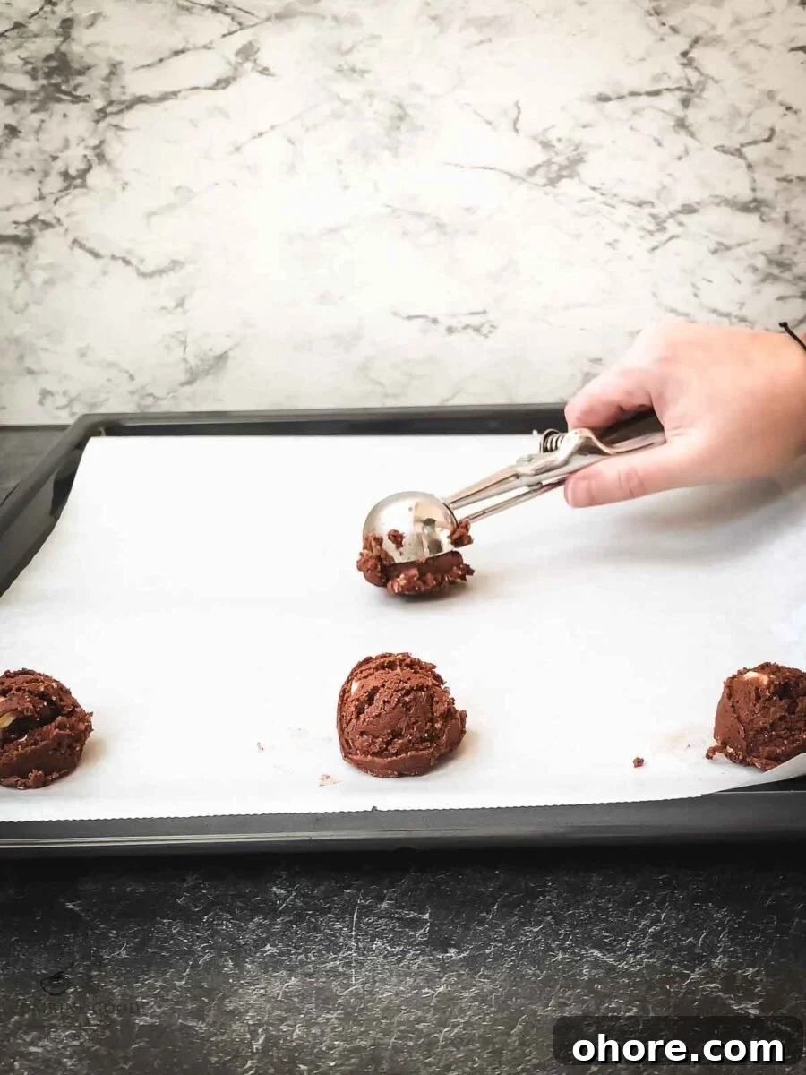 Scoop the cookie dough balls on a baking try lined with parchment paper.