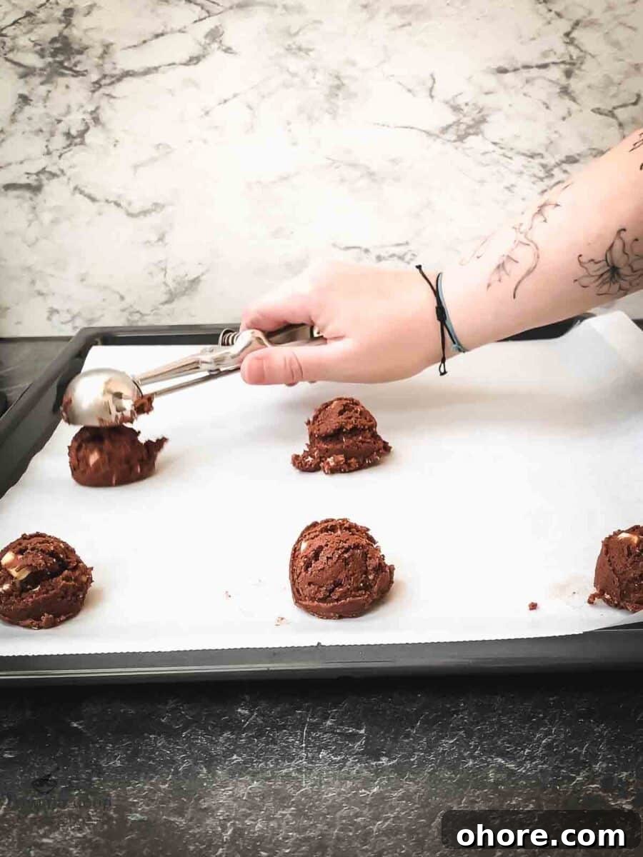 Scoop the cookie dough balls on a baking try lined with parchment paper.