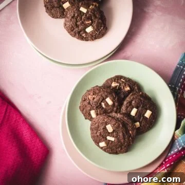 Divine white chocolate chip cookies with an incredible dark chocolate dough. Placed on pink-green plates.