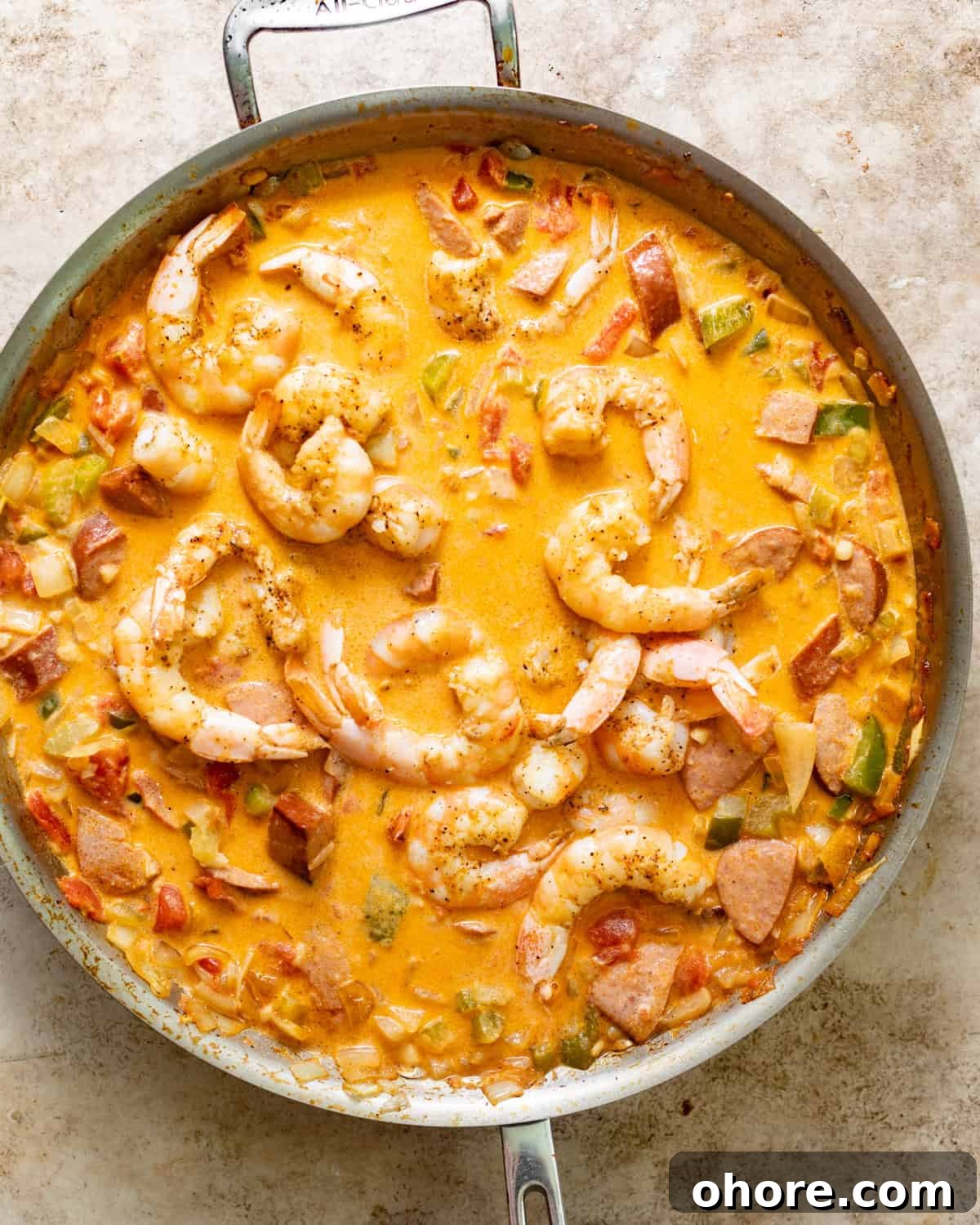 Cajun Shrimp and Creamy Cheddar Grits Recipe 7 cajun shrimp in a buttery sauce in a skillet.