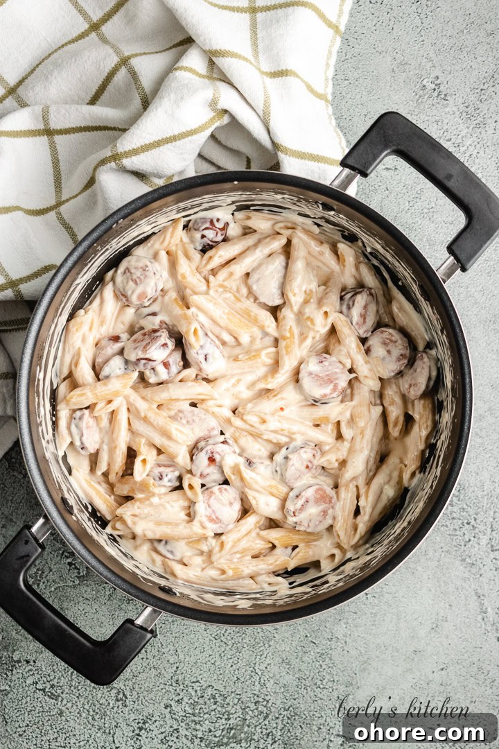 Creamy Kielbasa Pasta Recipe with Garlic Parmesan Sauce 6 The ingredients have been stirred into a creamy pasta.