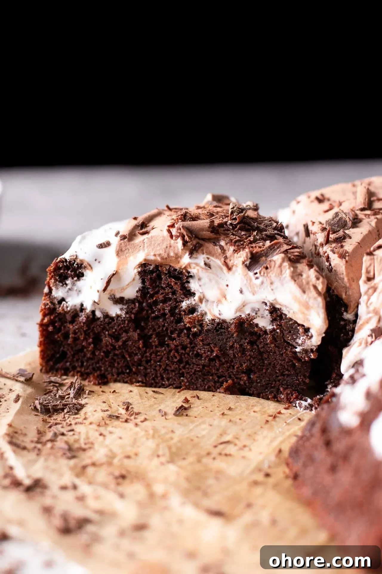 Decadent Hot Chocolate Poke Cake Recipe for Chocolate Lovers 2 sliced hot chocolate poke cake on parchment paper (5)
