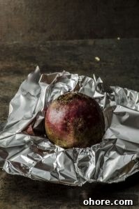 A beet ready to be wrapped in aluminum foil