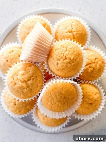 Mini honey muffins stacked on a plate.