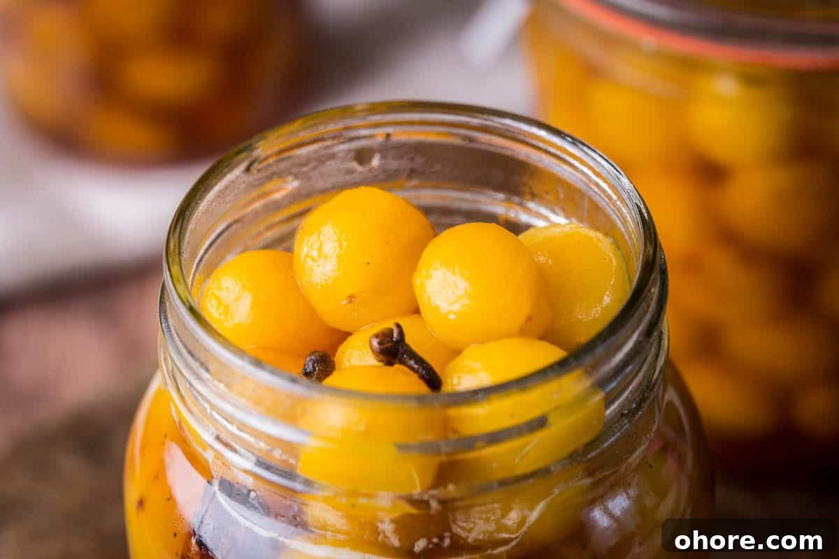 Pickled mirabelles packed into a sterilised jar.