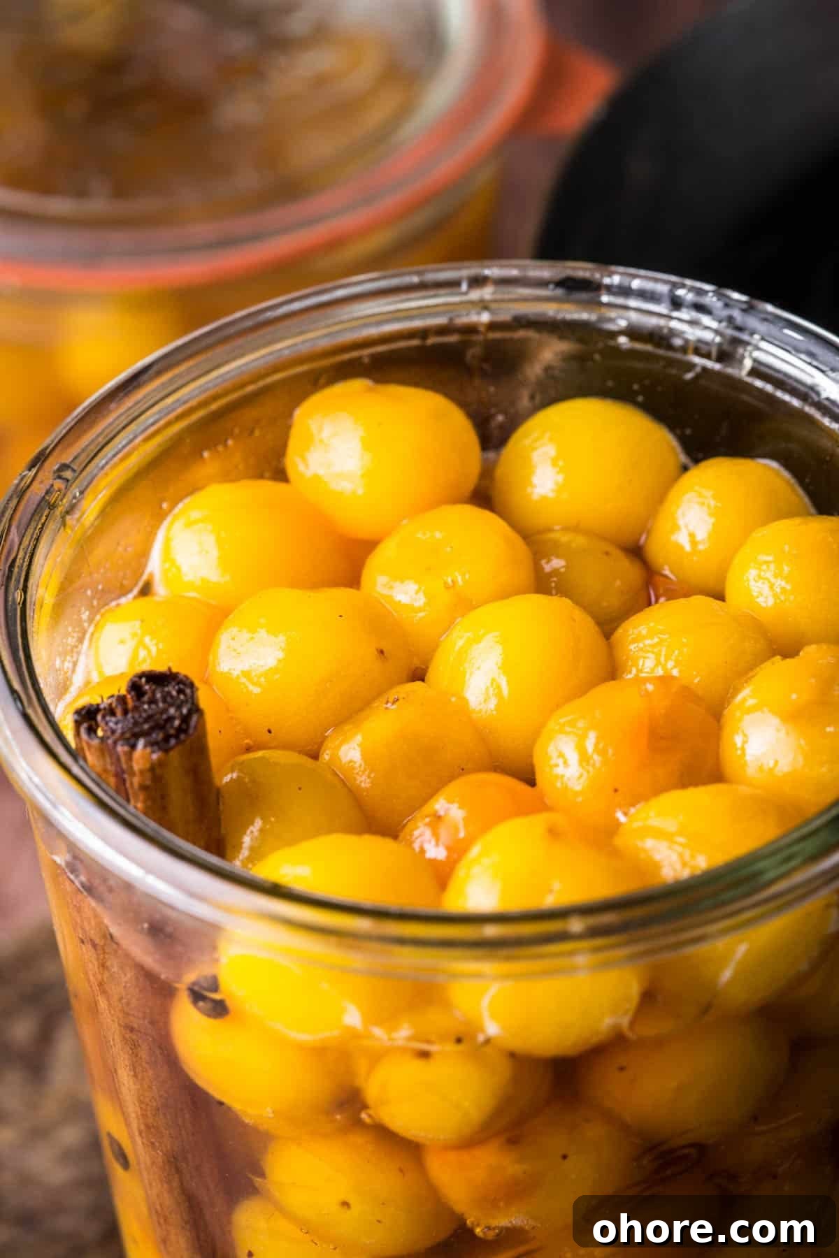 Pickled mirabelles packed into a sterilised jar.