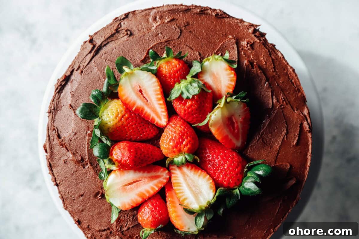 Decadent Chocolate Strawberry Layer Cake Recipe 7 overhead view of chocolate strawberry cake with fresh strawberries on top.